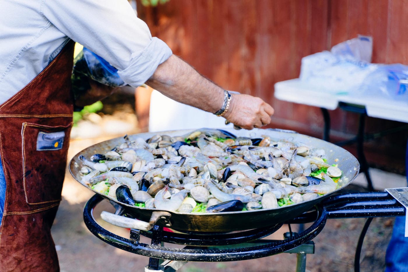 Professional chef preparing dishes at an outdoor food event, ideal for occasions like a confirmation.