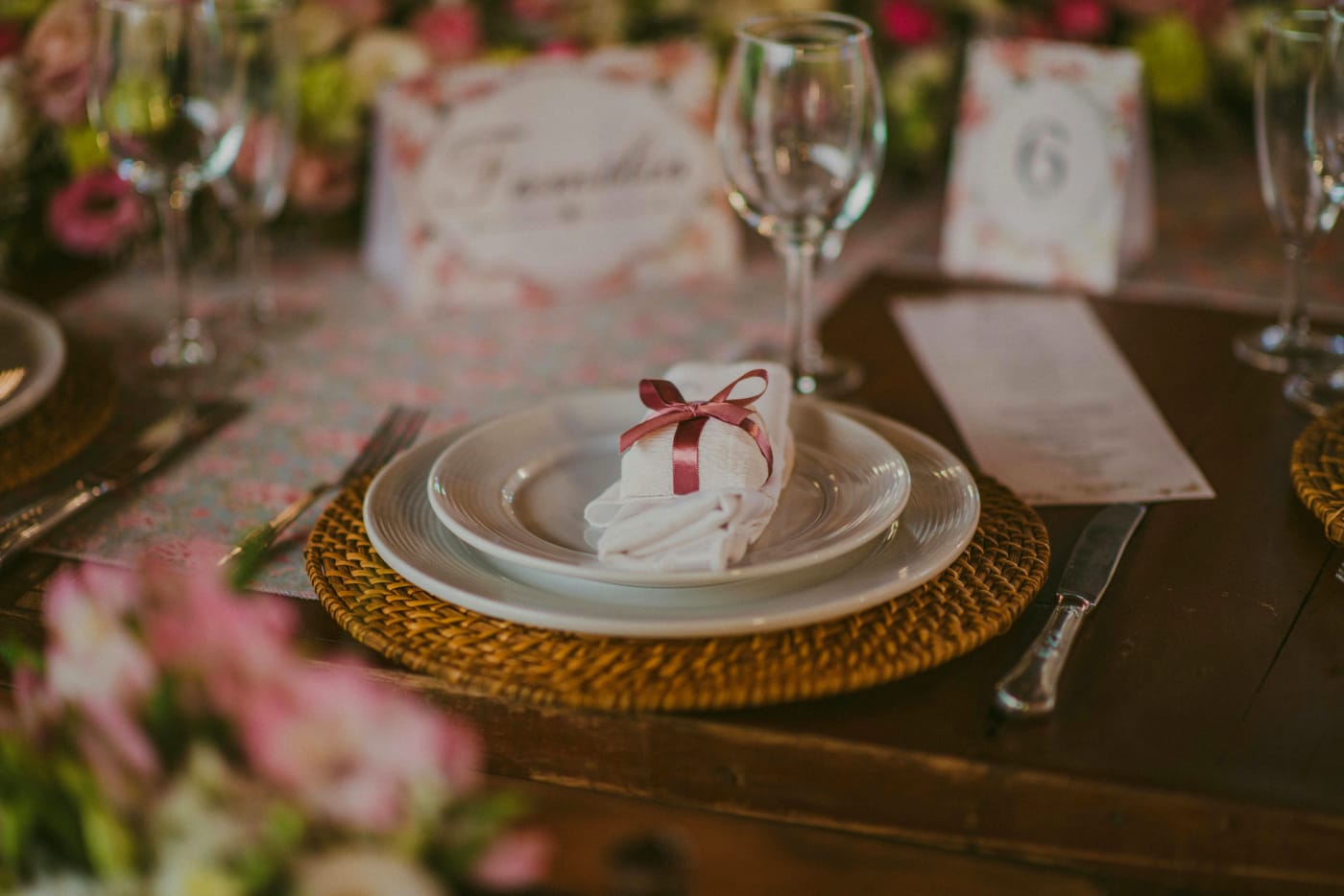 Elegant wedding table with beautifully set plates and flower menu, ready for a customized wedding menu.