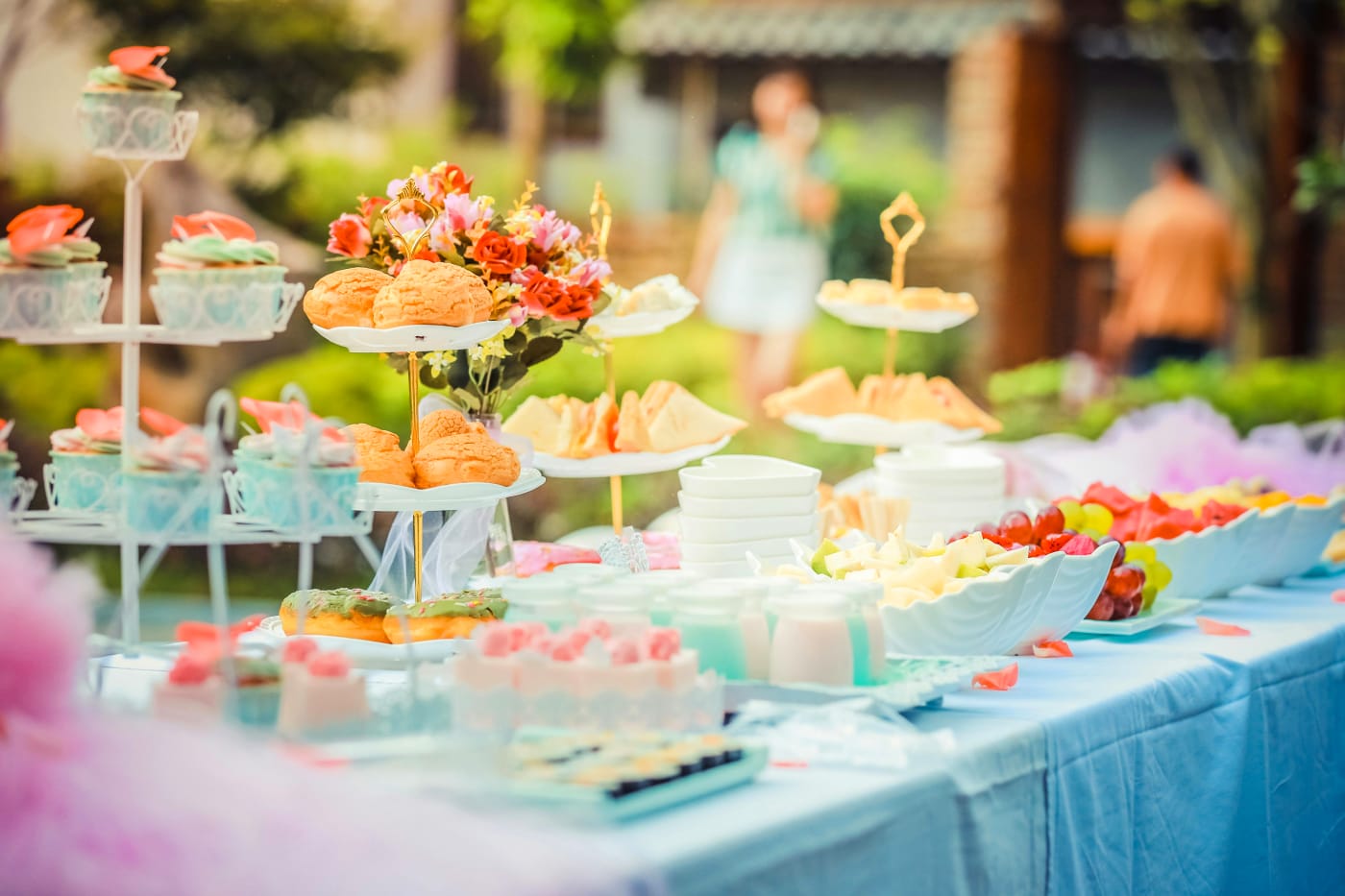 Festive summer buffet with colorful decorations and varied food selection for the companys summer party.