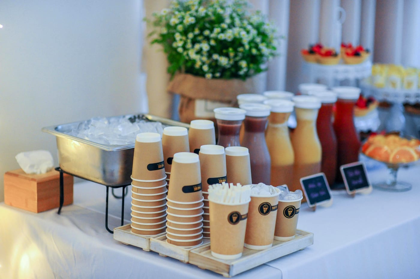 Buffet setup with drinks and cups for a company event, illustrating the choice of buffet for party planning.