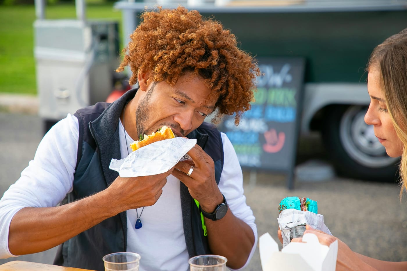 Guests enjoying street food at a food truck during a summer party, creating an authentic street food experience.