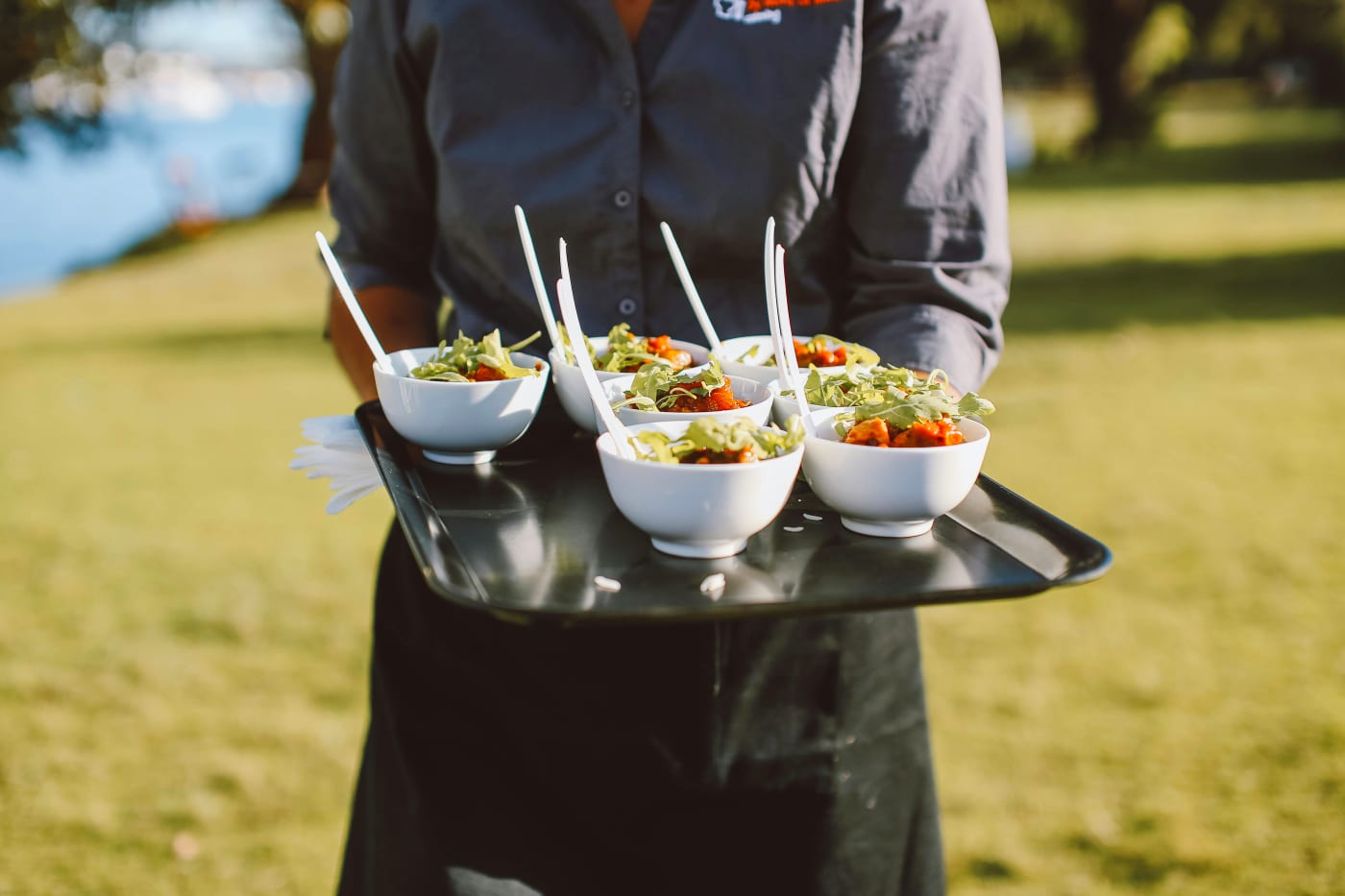 Serving festive dishes in bowls, perfect for birthday party catering and meal planning.