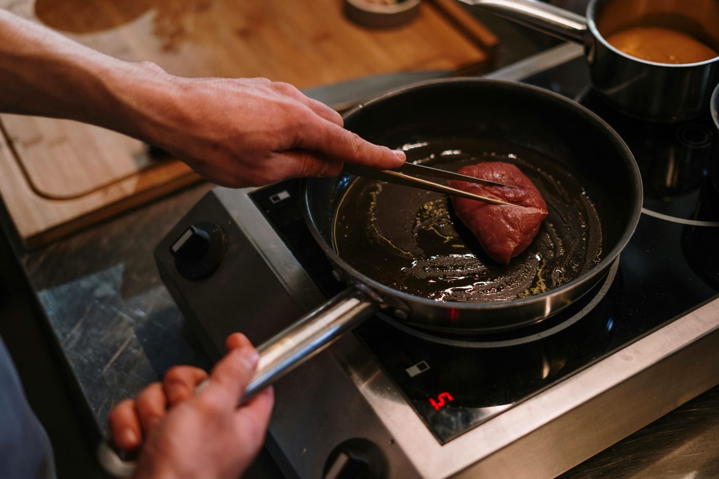 Professional chef preparing exclusive steak for private party, focus on ingredients and serving