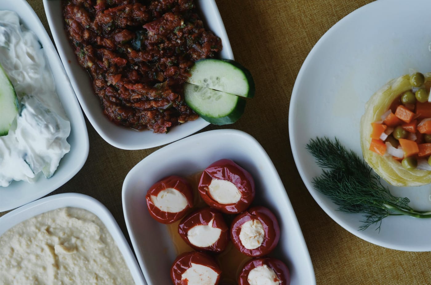 Variety of vegetarian appetizers with dips and stuffed vegetables, perfect for a colorful and tasty appetizer menu.