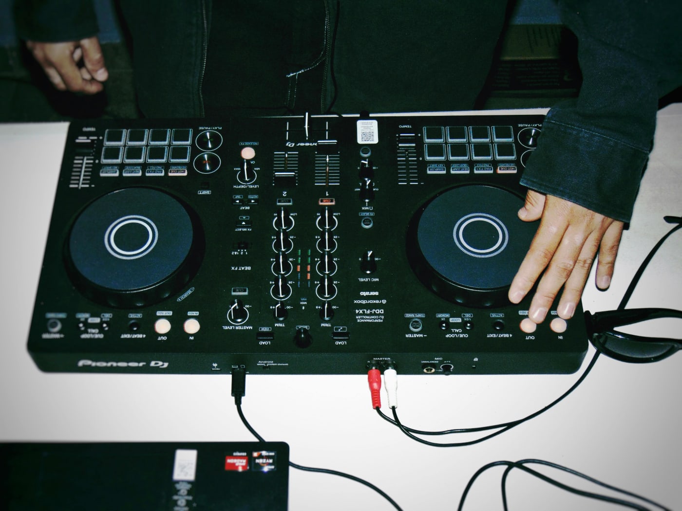 DJ at a mixer table creating party vibes with music for the birthday party, engaging guests and matching personality and taste.