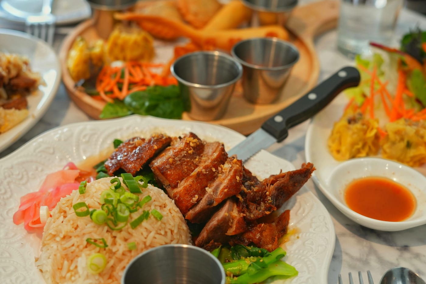 Image of Asian starters with rice, meat, vegetables, and dip, perfect for festive flavor experiences.