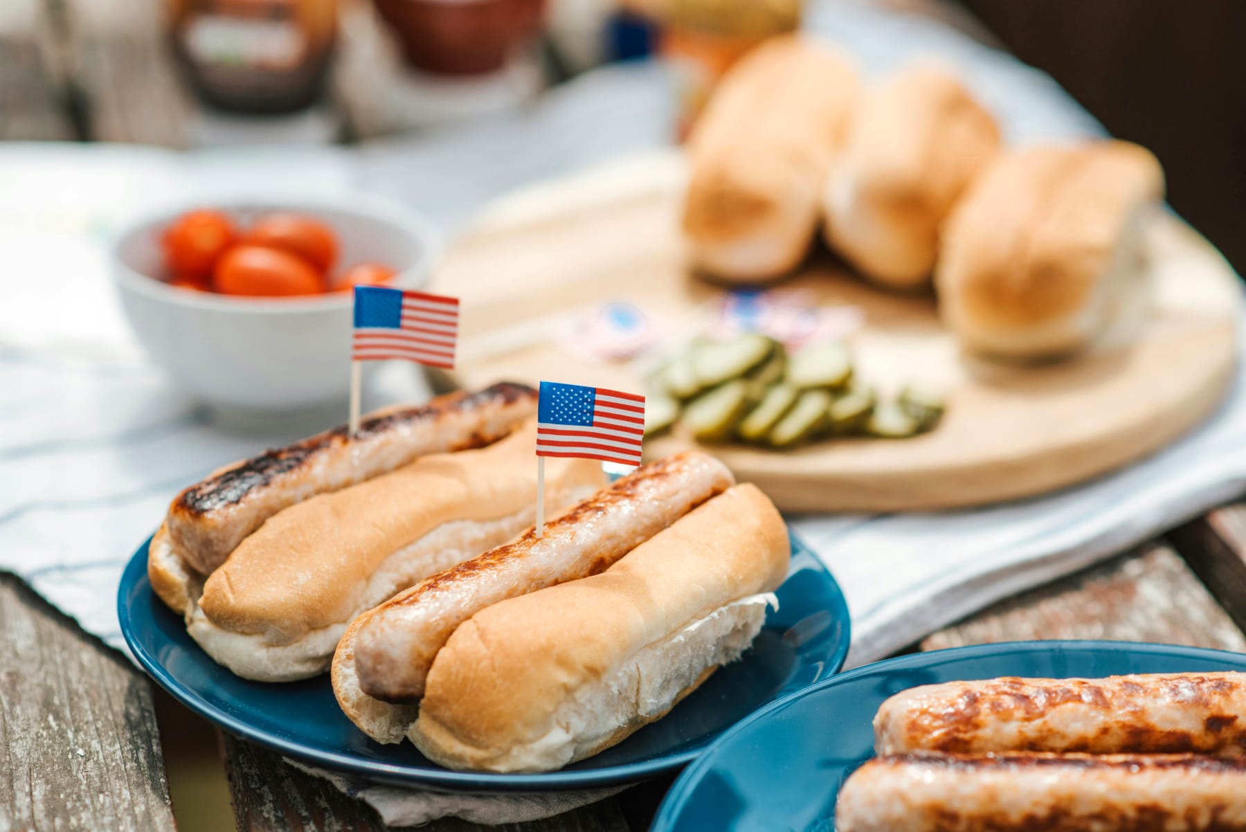 American party food with hotdogs decorated with small USA flags, perfect for an American-themed party.
