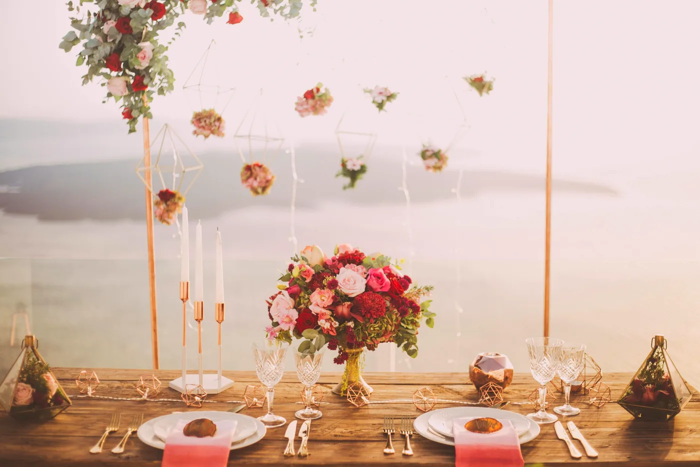 Elegant table setting with floral decorations and candles for a confirmation party, creating an inviting and festive atmosphere.