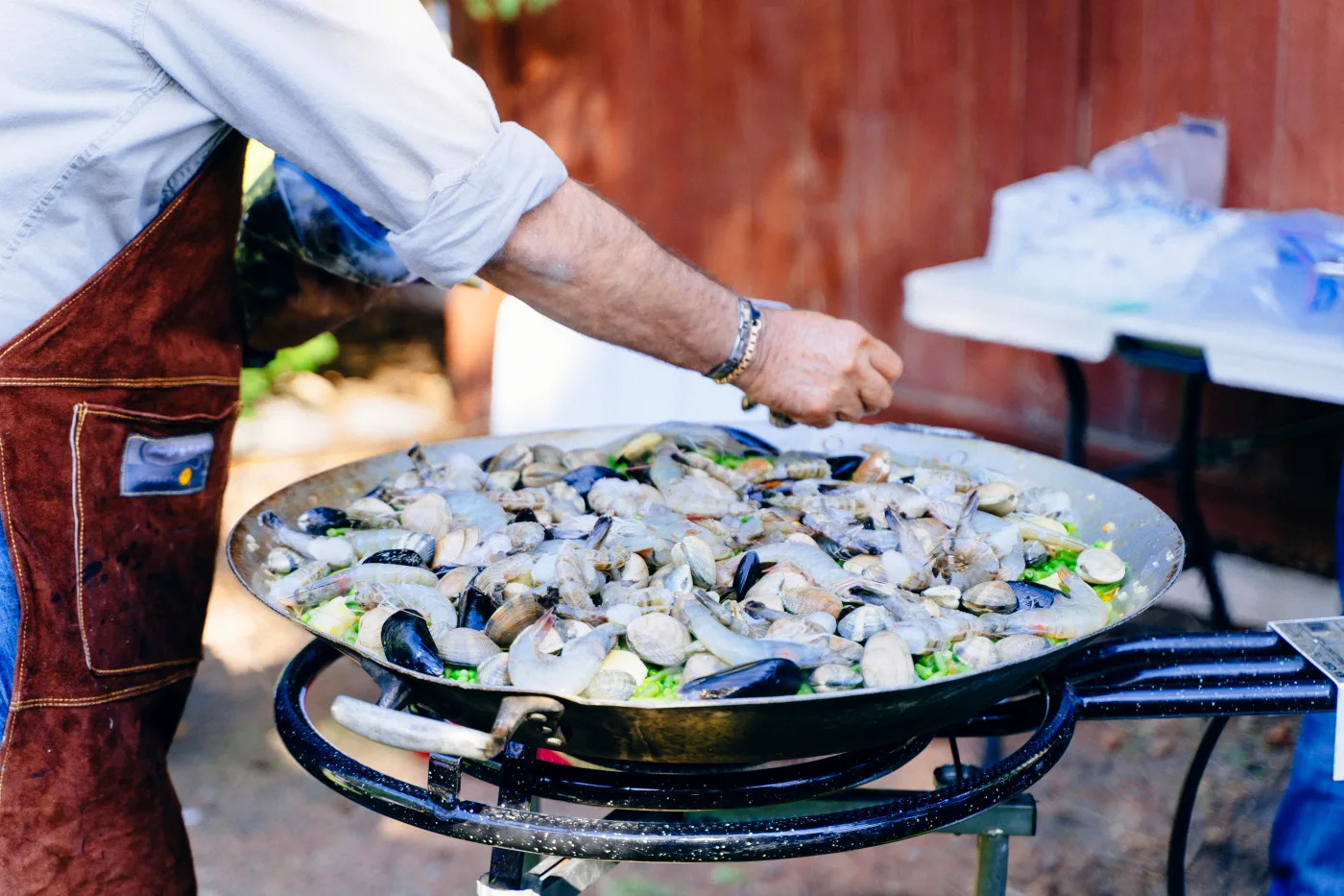 Professional chef preparing dishes at an outdoor food event, ideal for occasions like a confirmation.