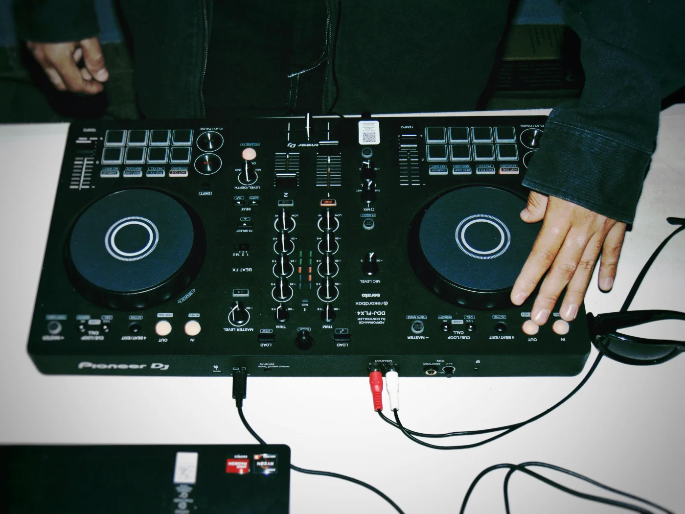 DJ mixer in action with focus on music as the partys focal point, creating lively atmosphere and energy.