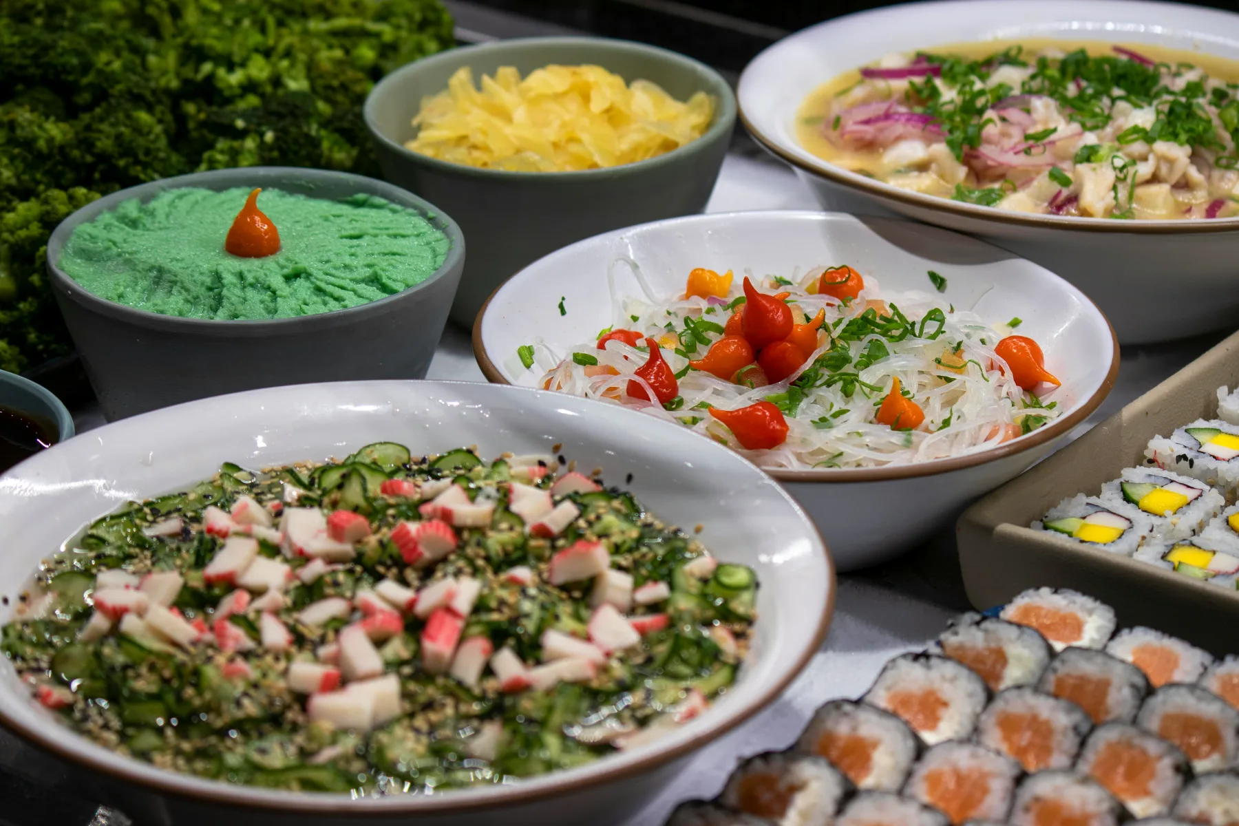 Varied selection of flavorful dishes that present exciting sides for your dinner menu, including fresh salads, noodles, and sushi.