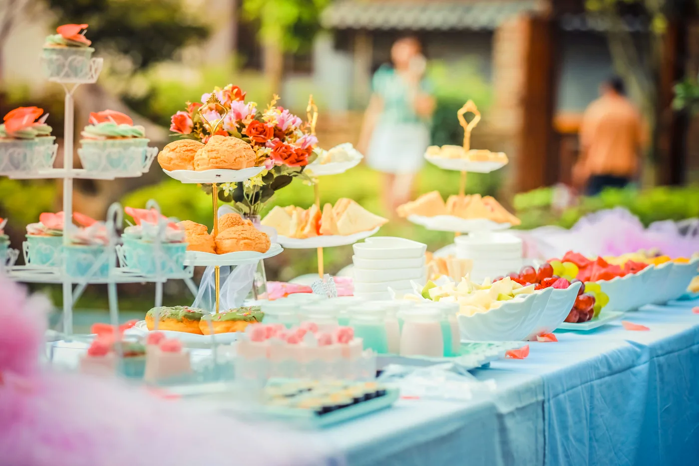 Festive summer buffet with colorful decorations and varied food selection for the companys summer party.
