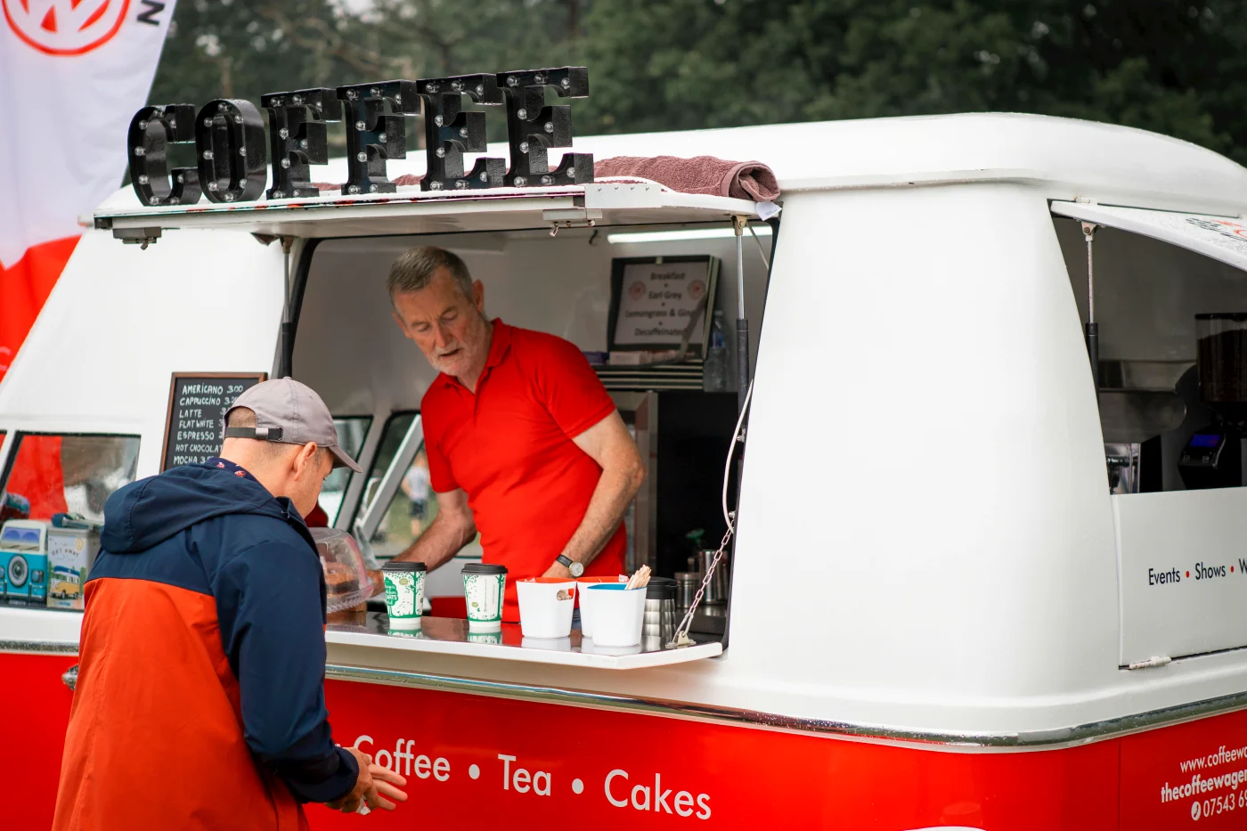 Food truck serving coffee at an outdoor company event, highlighting the flexibility and unique food experience at a summer party.