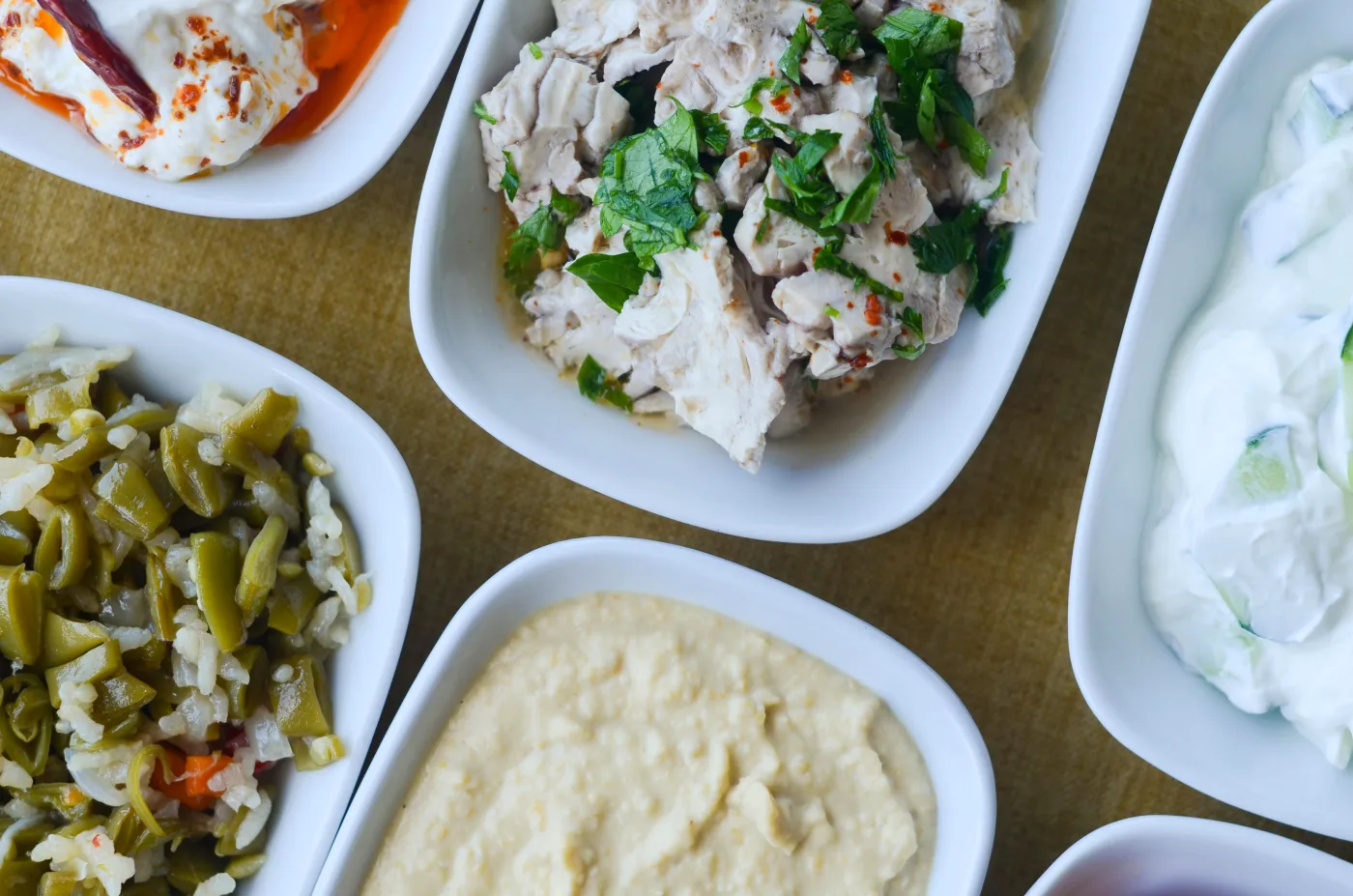 Variation of different types of side dishes presented in small bowls, highlighting their importance in the dinner menu.