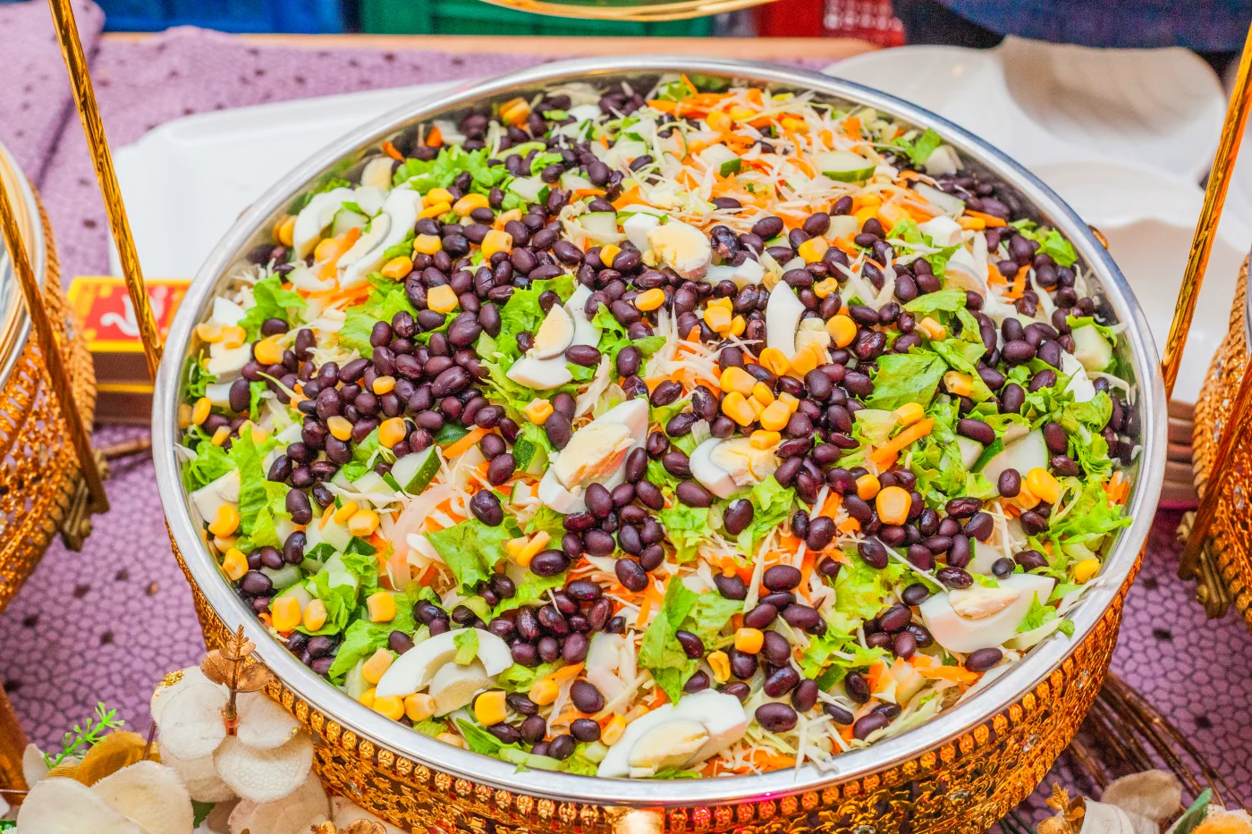 Colorful bean salad with black beans, corn, and fresh vegetables in a large bowl, perfect as versatile side dishes for meals.
