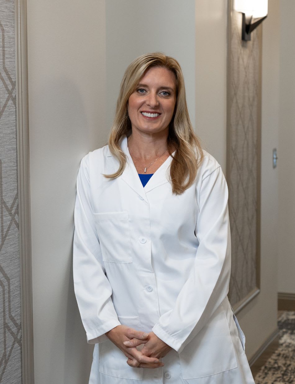 A smiling dentist in a white coat