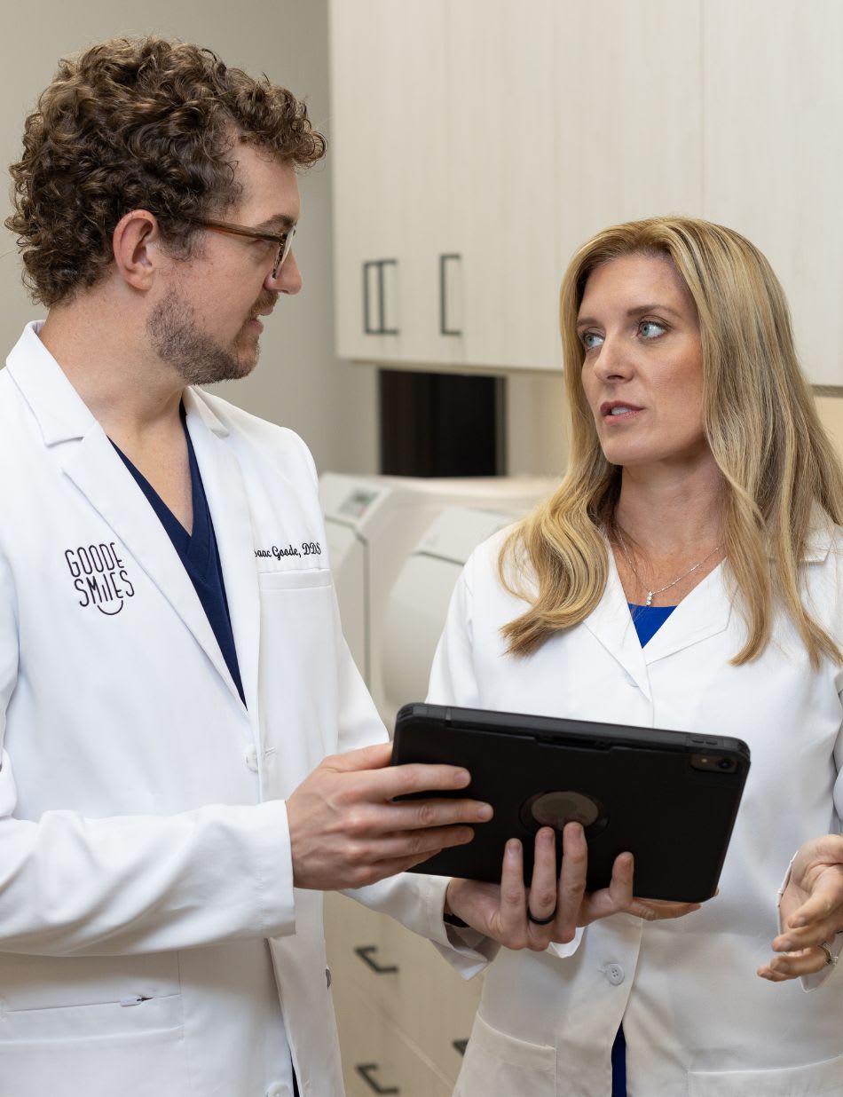 Two dentists reviewing a tablet together