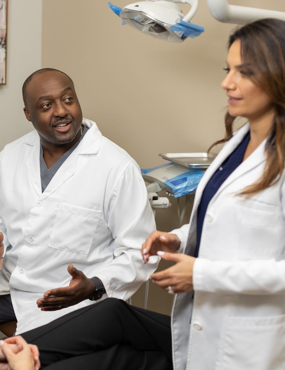 Two dentists talking in an exam room