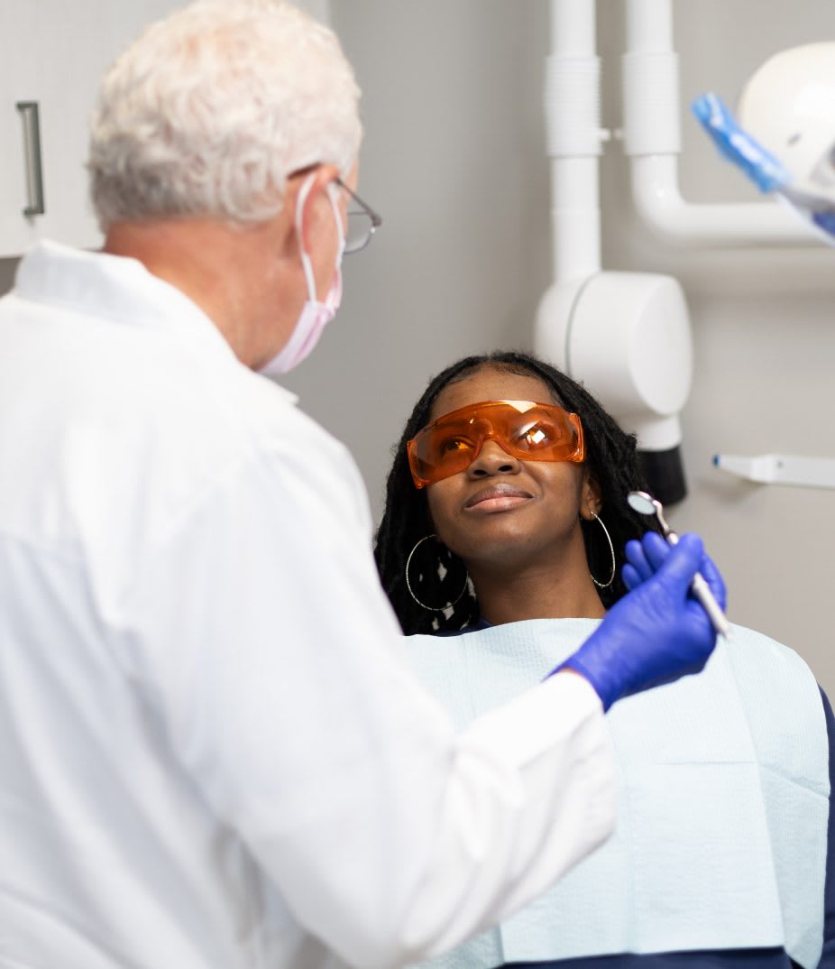 An Orahh Care dentist talking with a patient
