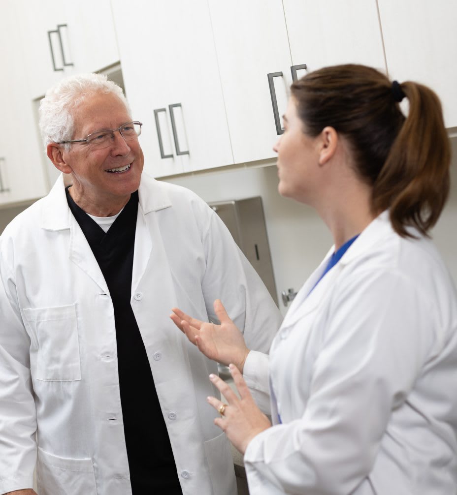 Two Orahh Care clinicians talking in a treatment room