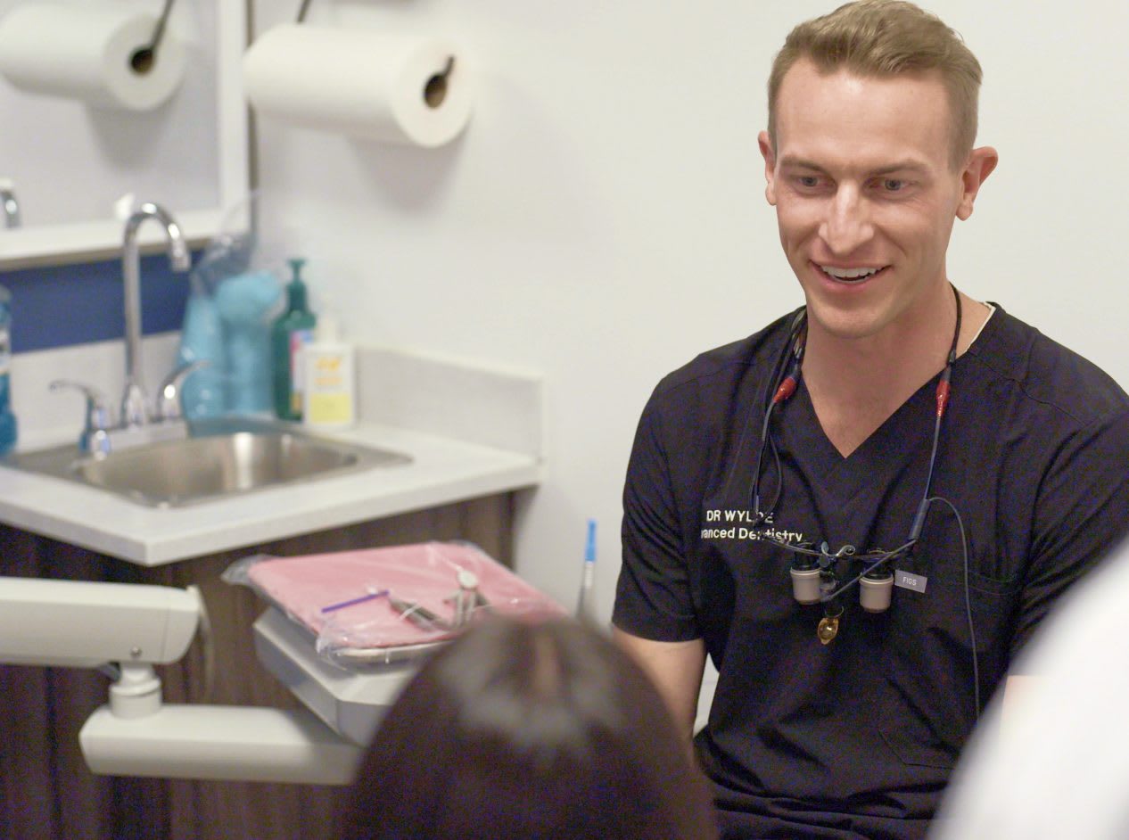 An Orahh Care dentist reviewing a treatment plan with a patient