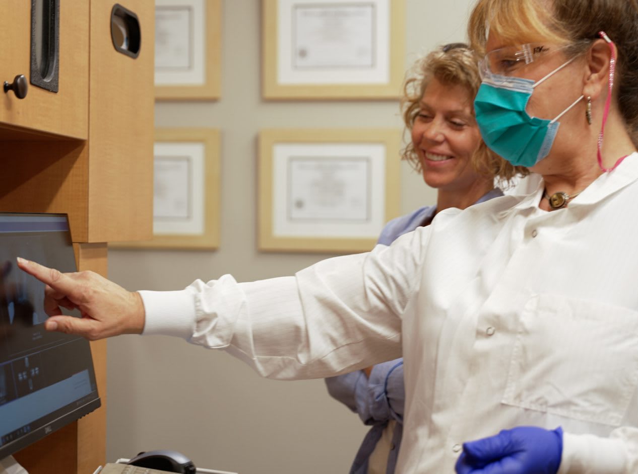 A dental hygienist working with a patient during a preventive visit