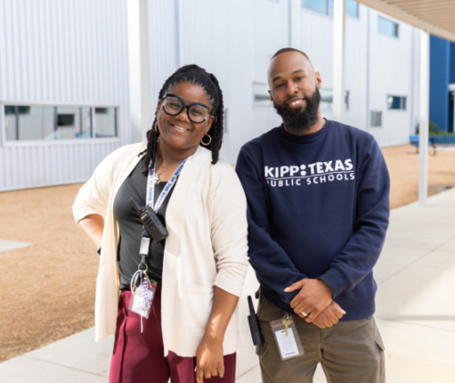 Two KIPP Texas staff members standing in front of a school building