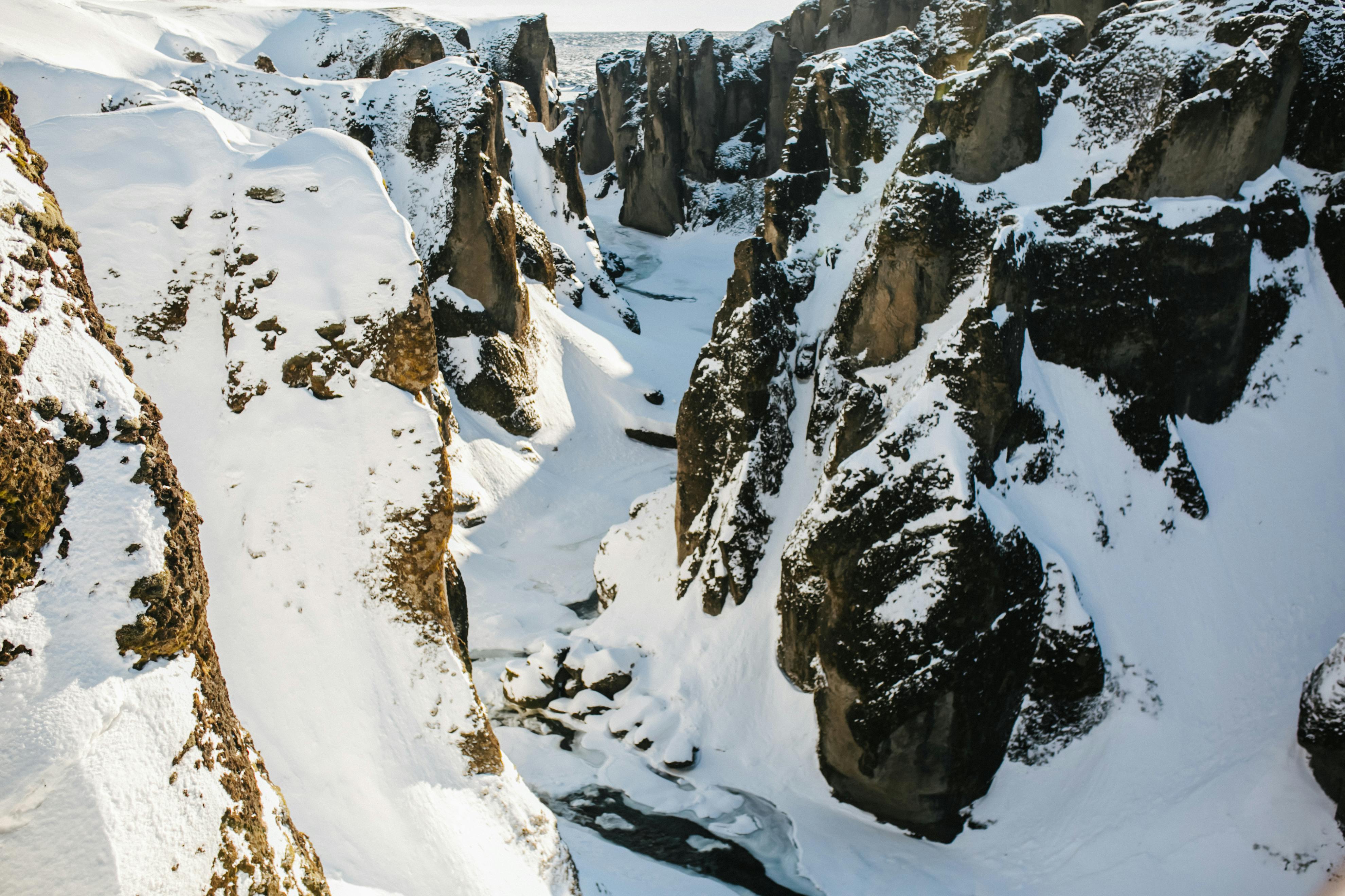 Explore the breathtaking snowy canyon landscape captured in winter from an aerial perspective.