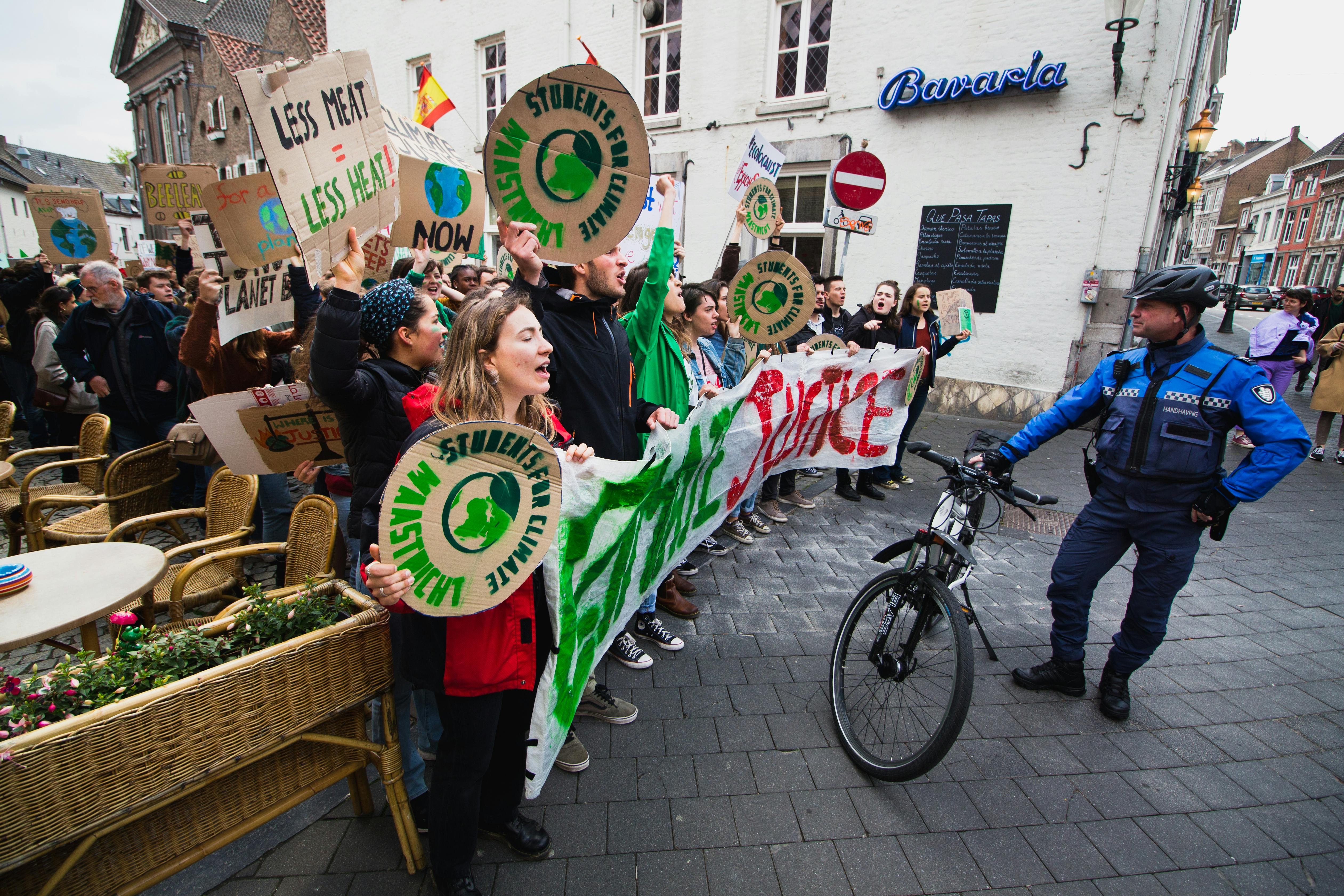 Protesters rally in Maastricht advocating for climate action and environmental justice.
