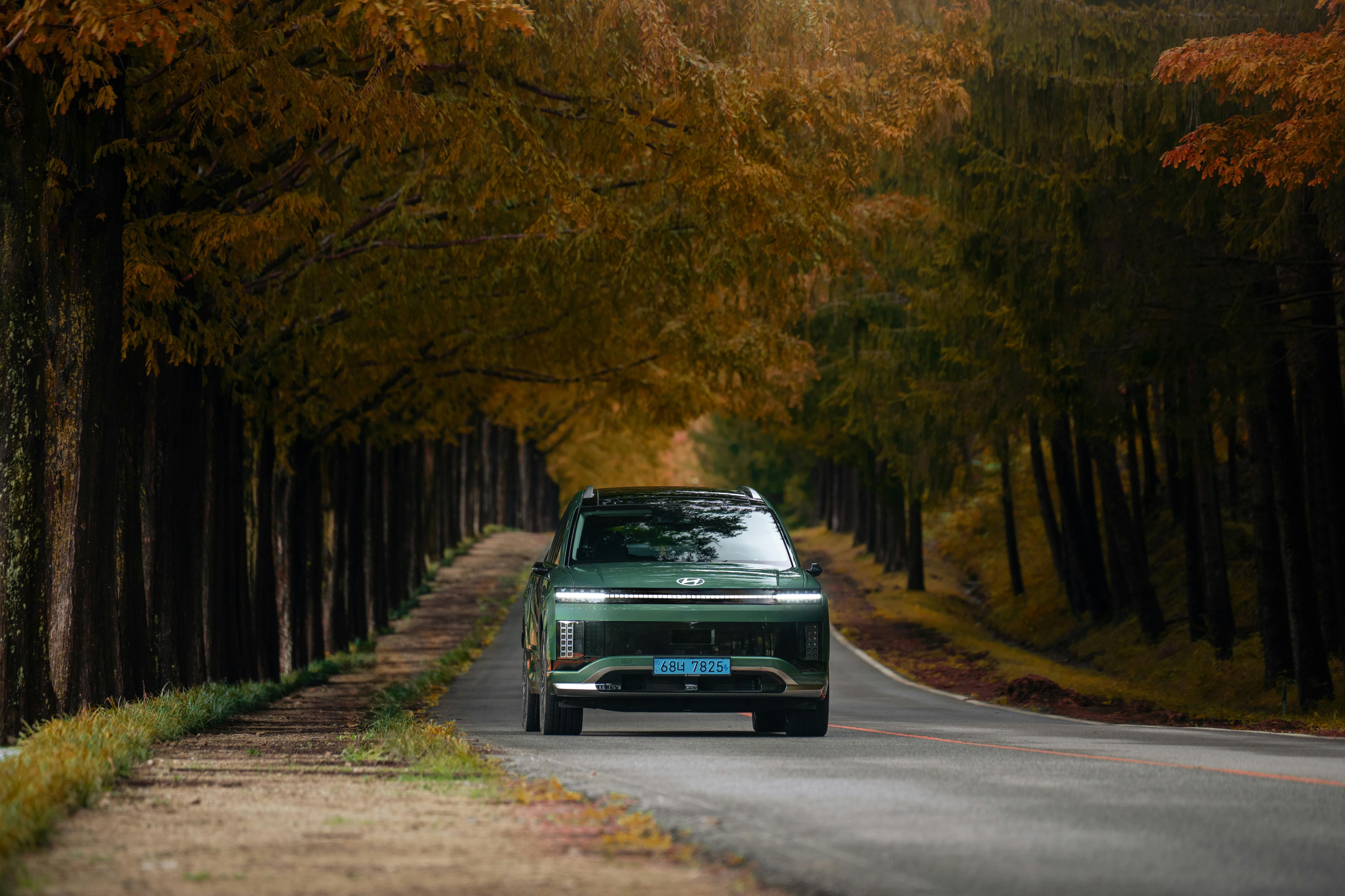 Dual Tesla electric car chargers in Idaho Falls parking lot with clear blue sky.