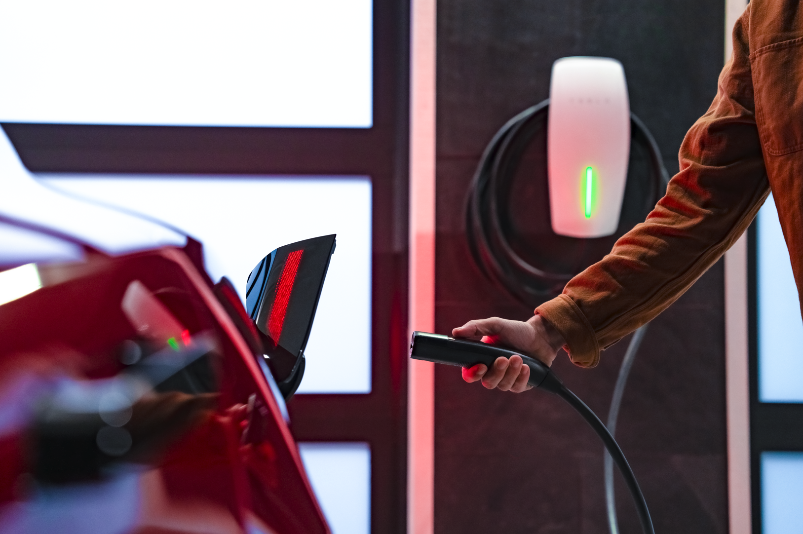 EV Electric Vehicle Being Plugged In Charging Connected