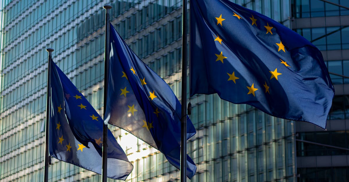 EU flags waving in front of the European Commission building in Brussels, Belgium.