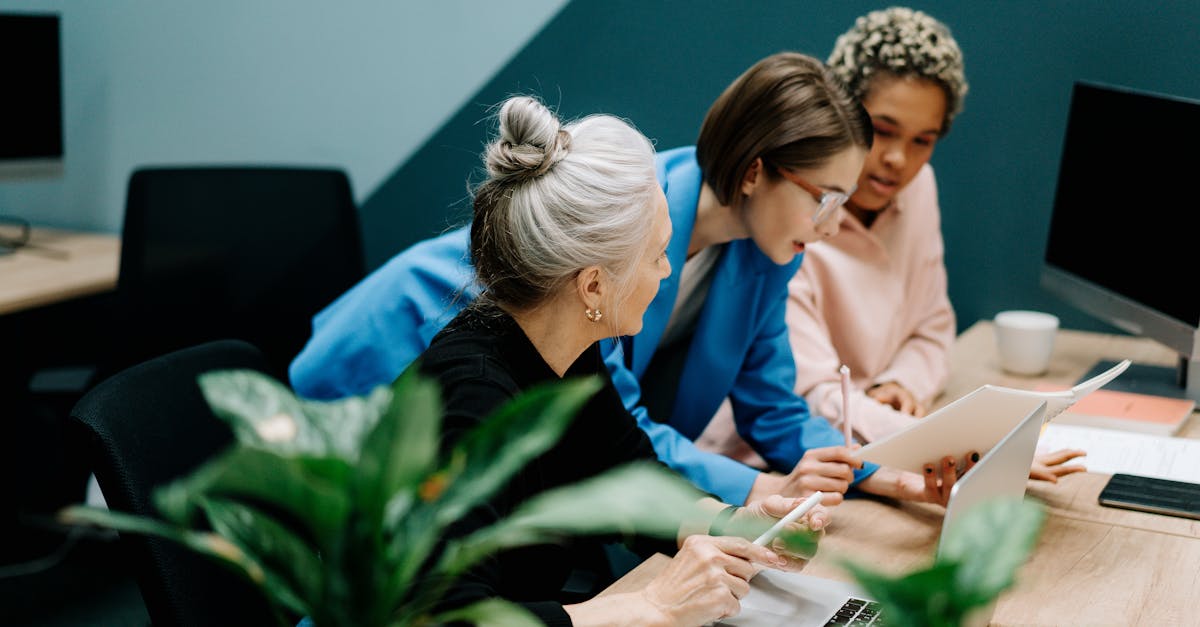 A diverse group of professionals collaborate on a project in a modern office environment.