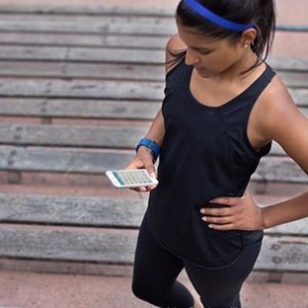 girl using Fitbit fitness watch