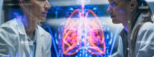 Doctors discussing patient case with holographic anatomy display in high-tech medical facility&nbsp;