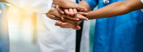 Medical team unity: healthcare professionals stack hands in hospital setting.&nbsp;