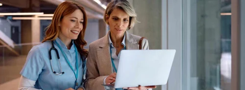 A clinician and a hospital administrator review data on a laptop&nbsp;