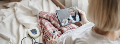 Remote telehealth consultation with senior woman using home monitoring devices.&nbsp;