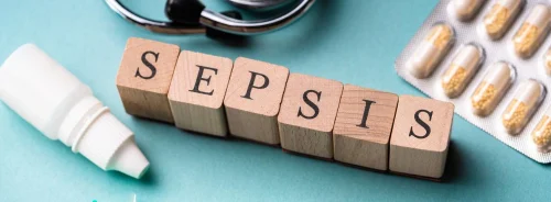Sepsis diagnosis and treatment concept with wooden blocks, stethoscope, syringe and medication.
