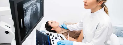 Female patient undergoing an abdominal ultrasound examination performed by a clinician using a modern ultrasound system to assess internal organs.&nbsp;