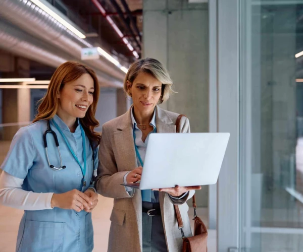 A clinician and a hospital administrator review data on a laptop&nbsp;