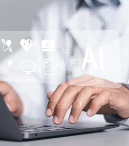 Clinician uses AI tools on a laptop to support care and documentation.&nbsp;
