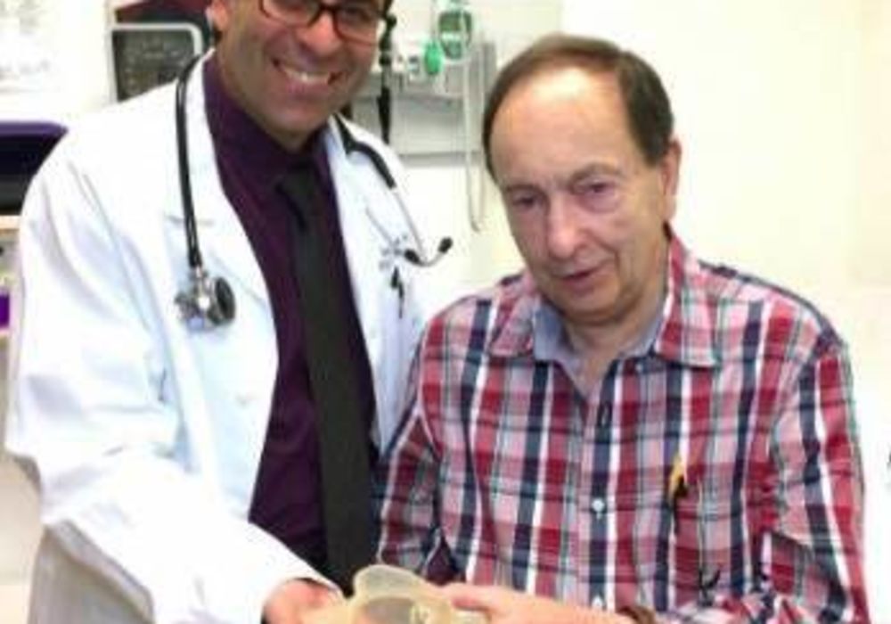 Dr. Jamil Aboulhosn and patient Richard Whitaker hold the 3D printed model of the patient&rsquo;s heart.