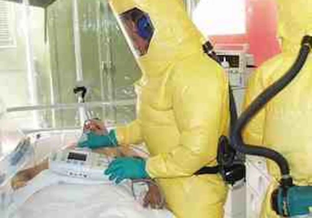 Patient in isolation with Ebola virus being cared for by nurses in protective gear