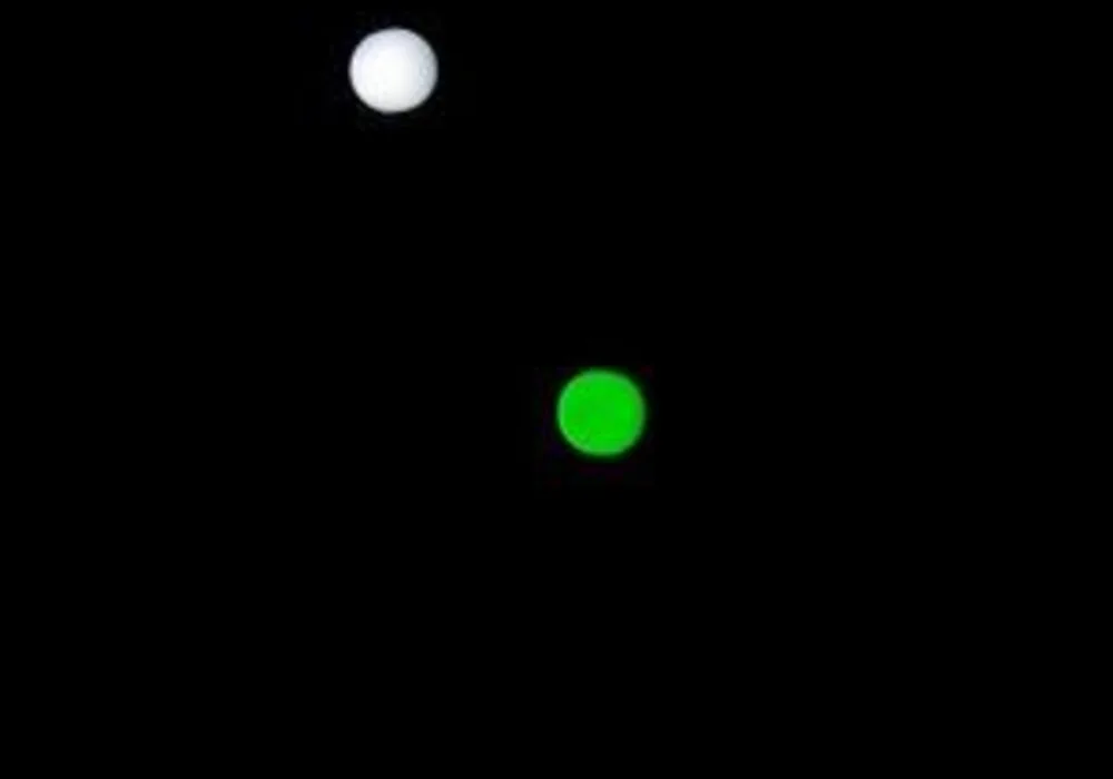 Black background and white and green light