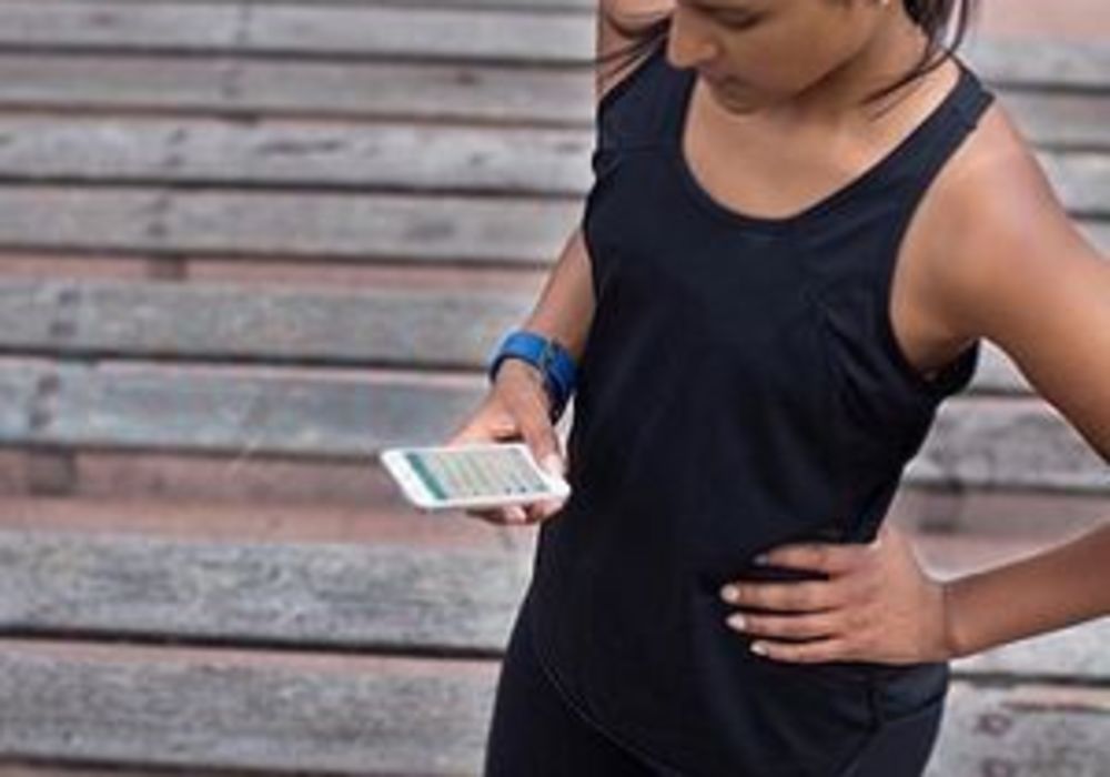 girl using Fitbit fitness watch