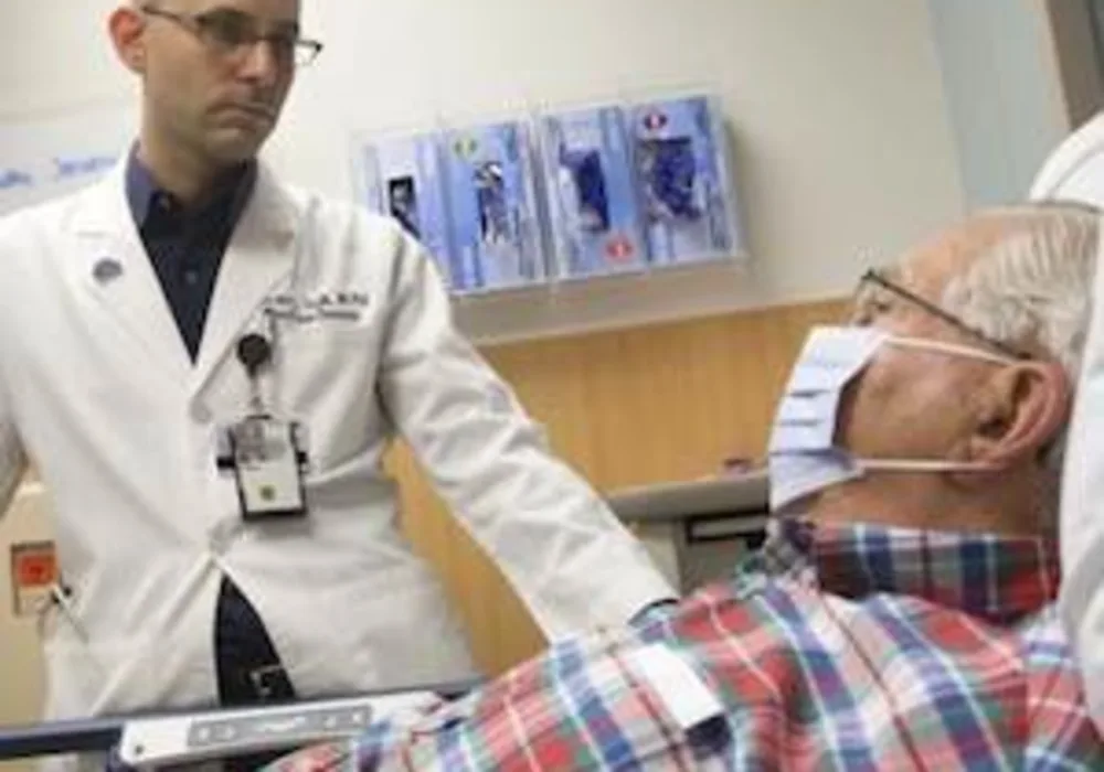 Ephraim Tsalik, MD, PhD, at Duke Health assesses a patient for respiratory symptoms. 