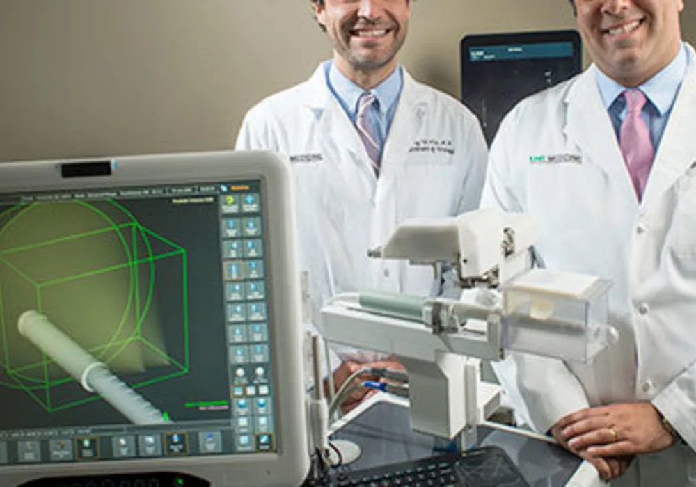 Jeffrey Nix, M.D., left, and Soroush Rais-Bahrami, M.D., with the iSR&rsquo;obot Mona Lisa, a new image-guided device for diagnosing prostate cancer prostate cancer