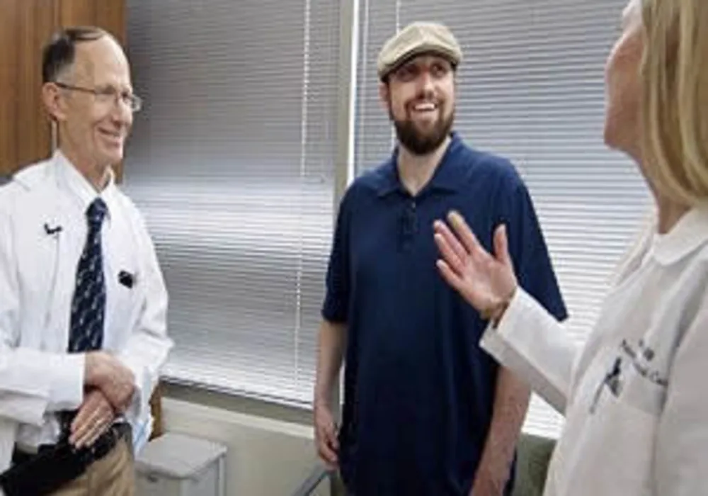 Richard Hotchkiss, MD, a professor of anesthesiology (left), and Jane Blood (right), a nurse manager in the Department of Anesthesiology&#039;s Division of Clinical and Translational Research, talk with Greg Porter, 34, of Nashville, Ill., who has recovered fr