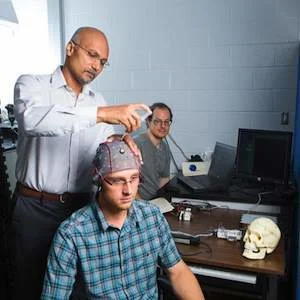 Dr. Sunderam with volunteer Dillon Huffman recording brain signals